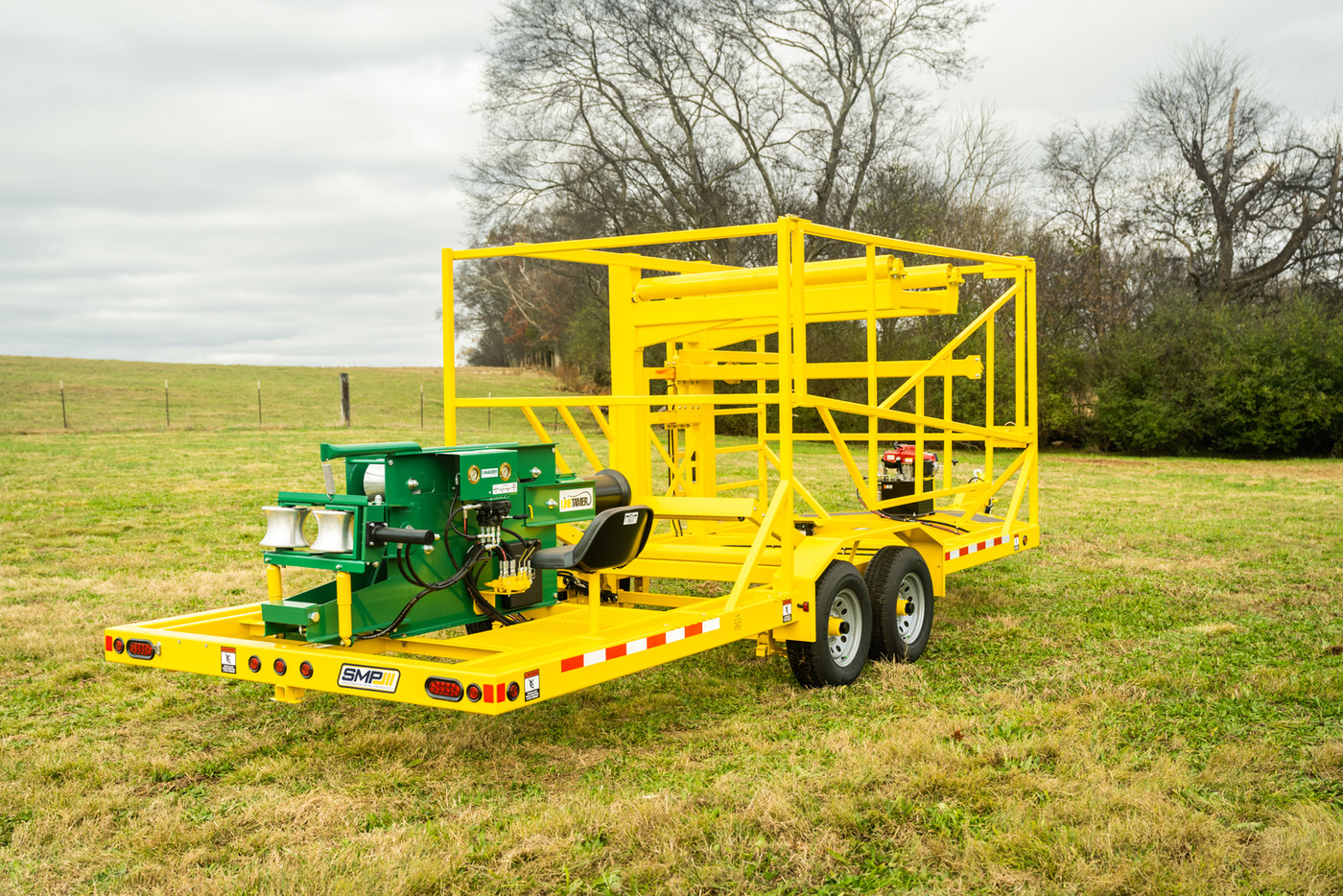 Yellow SMP CT2786C-LT HDPE pipe trailer in a field